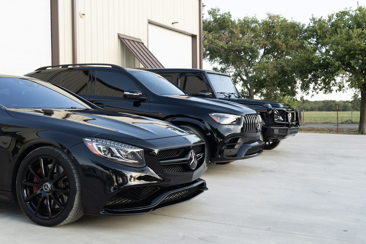 Vehicles lined up along the Airborne Dent Repair building at 489 Reed Ln in Gunter, Texas